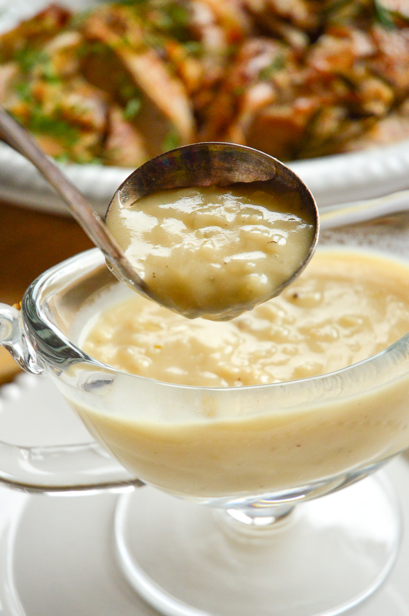 Gravy without drippings in ladle with turkey platter in background