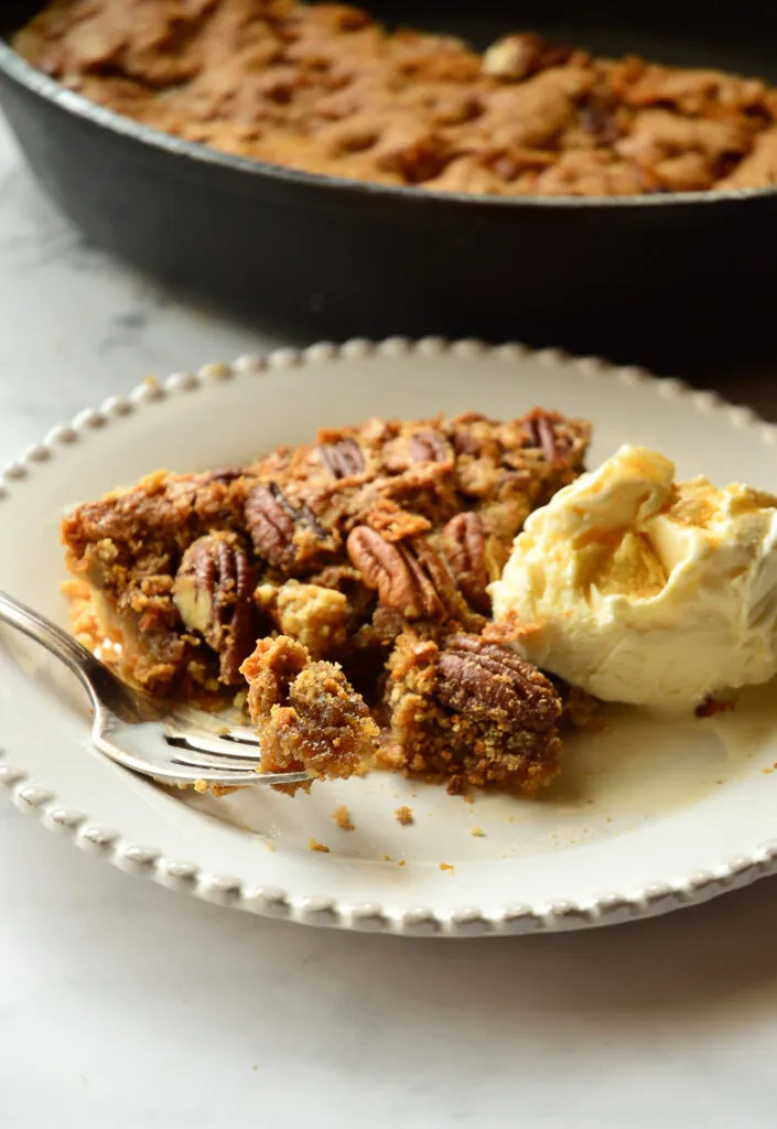 pecan pie recipe a la mode with fork on white plate