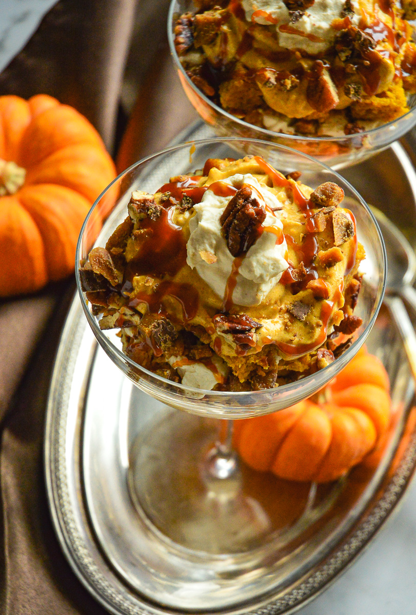 individual pumpkin trifle desserts on silver tray with pumpkins