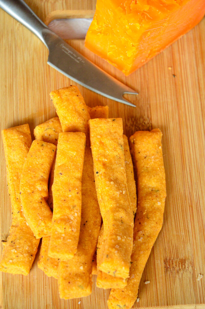 southern cheese straws recipe on cheese board with cheese knife