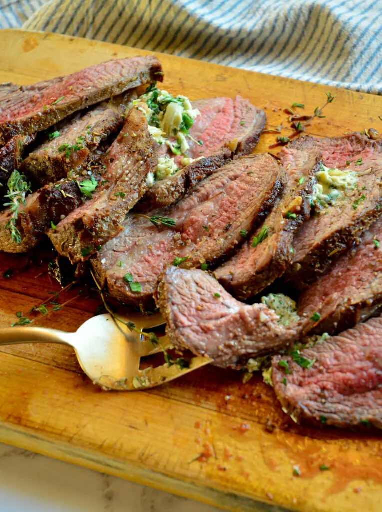 skillet to oven tri tip roast on cutting board with serving fork