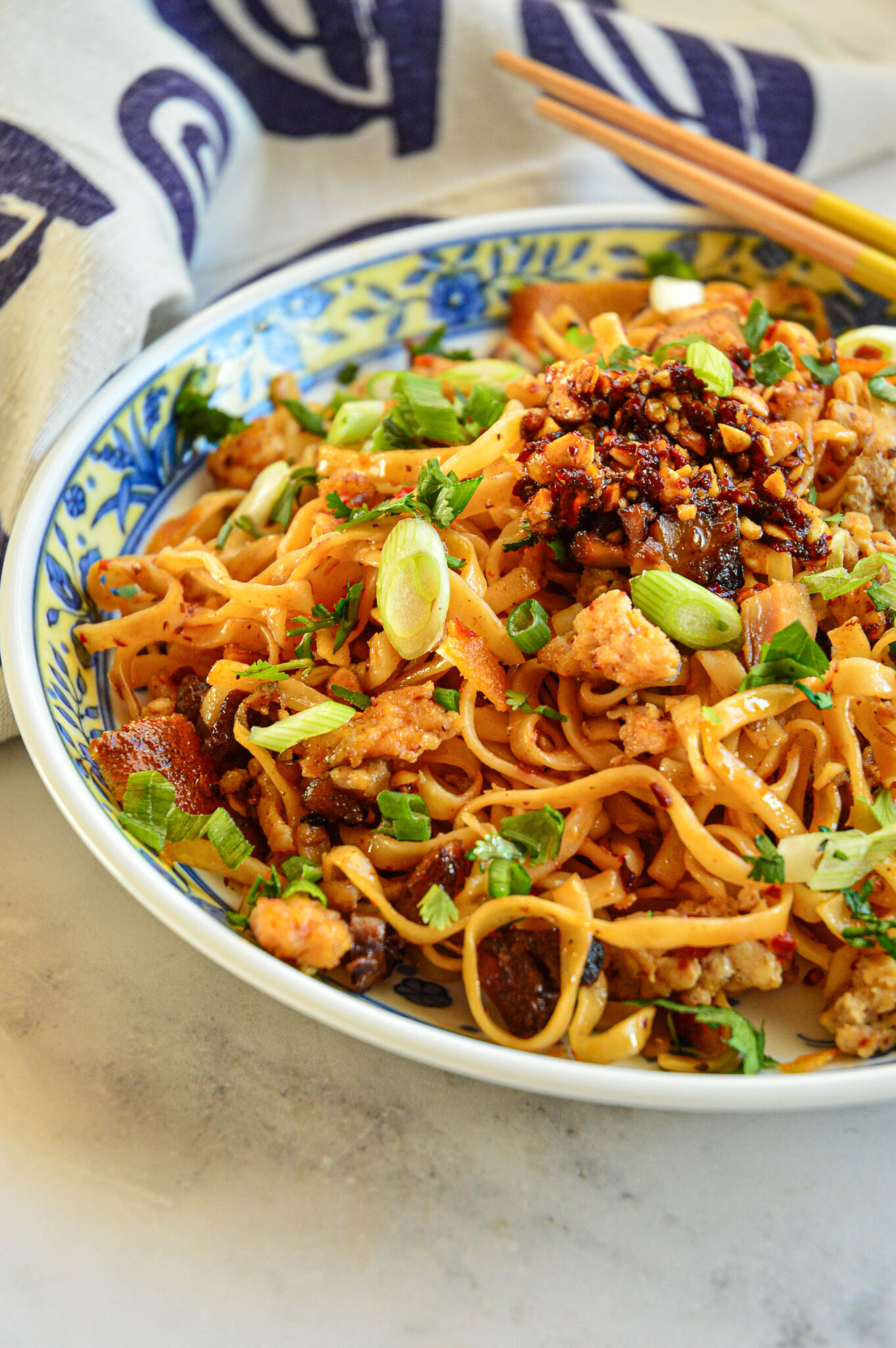 spicy chili garlic noodles recipe in bowl with chopsticks