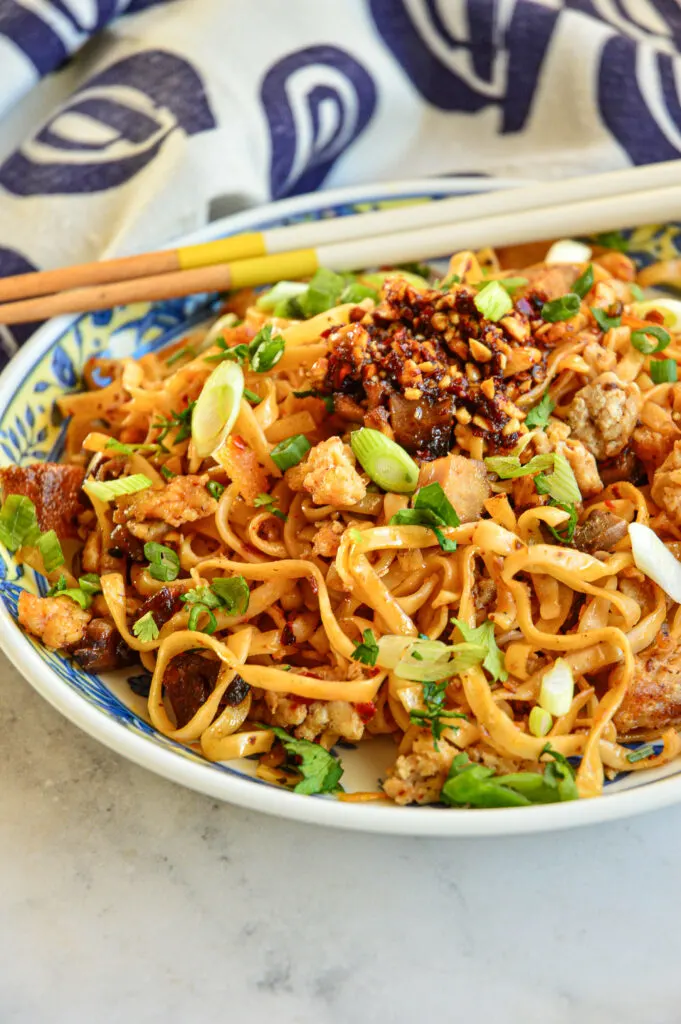 Chili Garlic Noodles with blue napkin and chopsticks