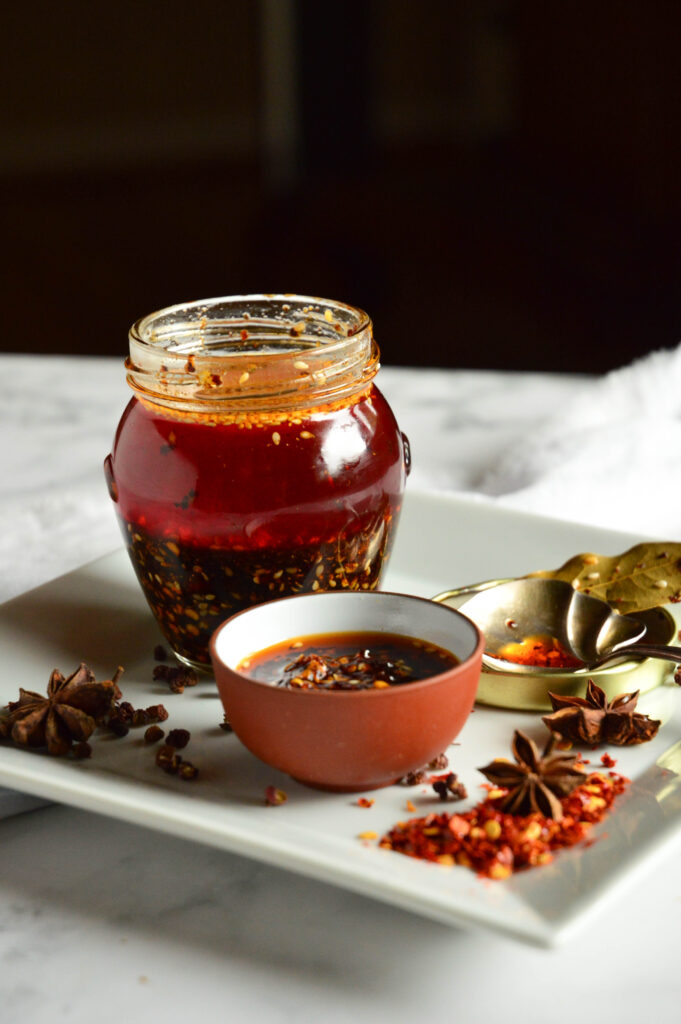 Chinese chili garlic sauce recipe on jar on plate with spices
