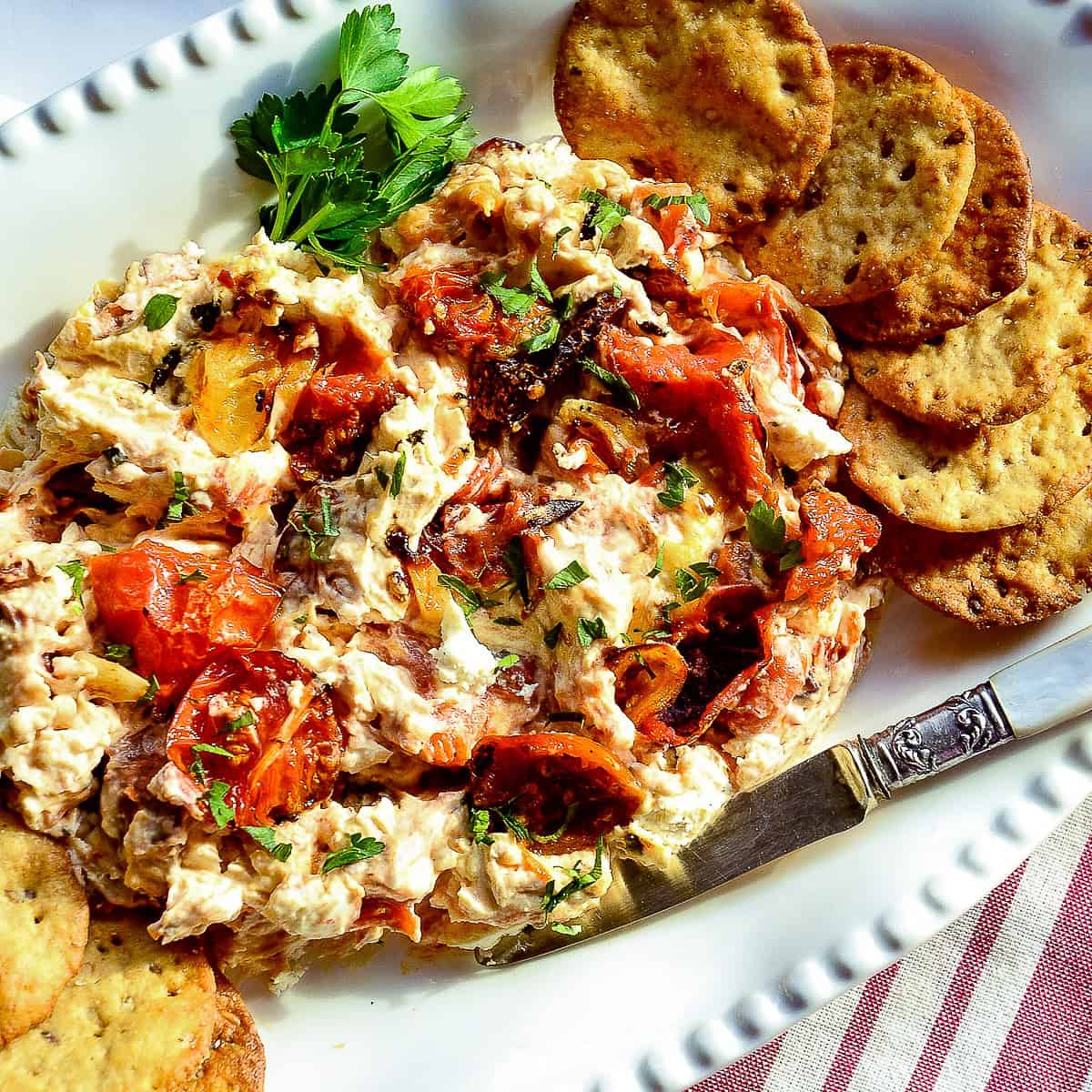booursin cheese appetizer recipes with boursin and roasted tomatoes on whitee plate with crackers
