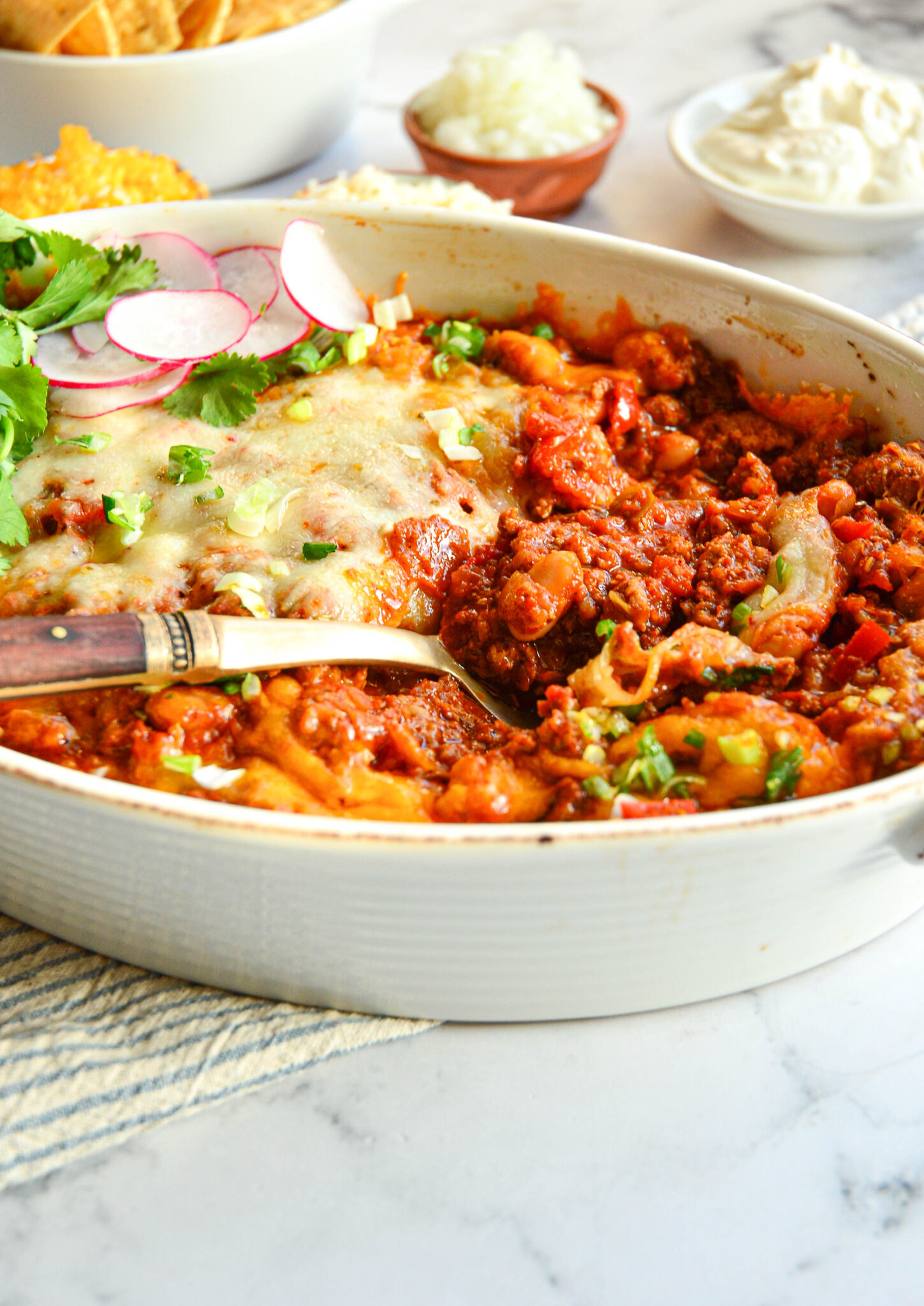 chicken taco casserole recipe in white baking dish