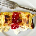Blintz Souffle Casserole on white plate with jam