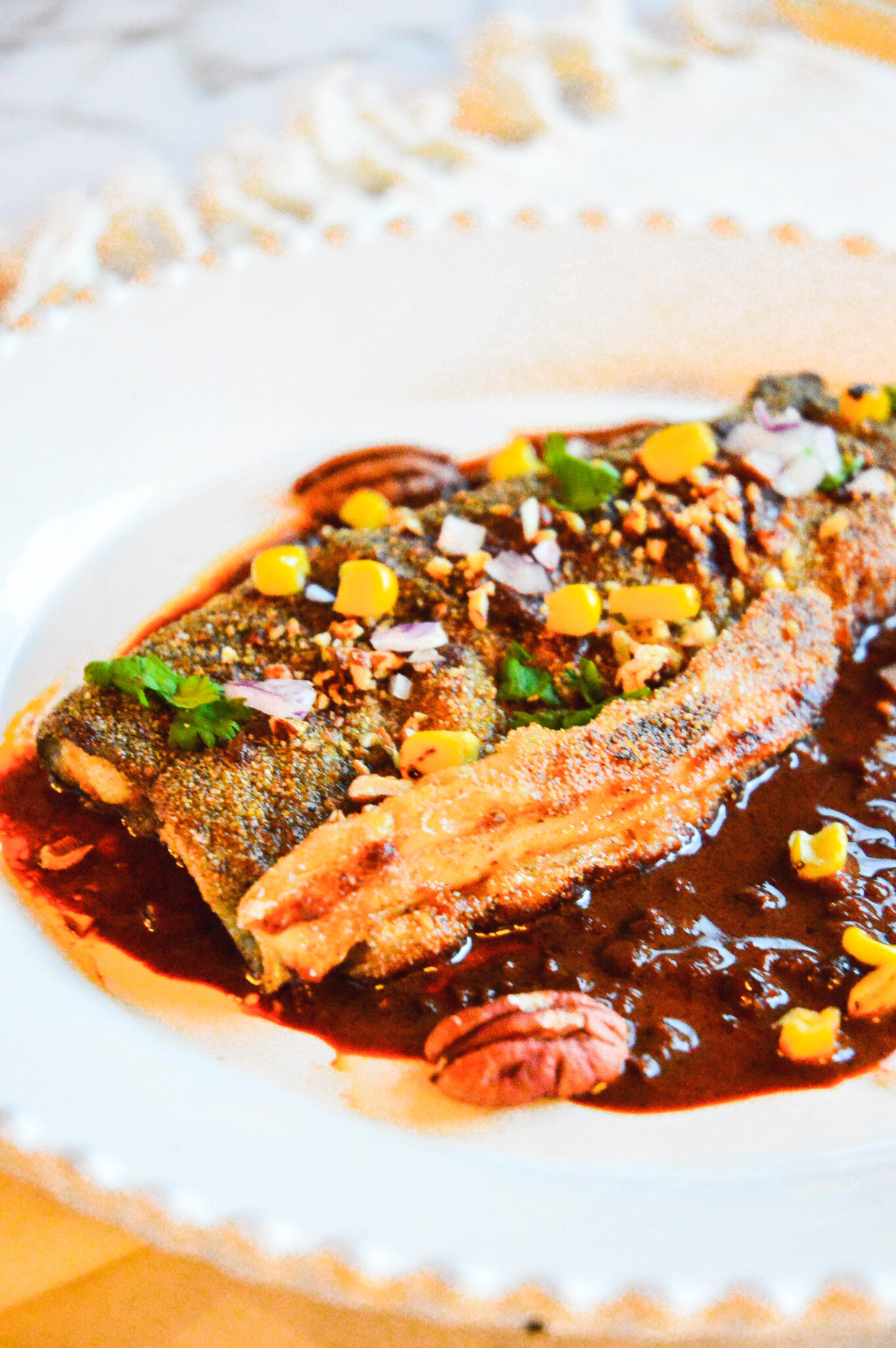 pan fried rainbow trout recipe with red chili on white plate.