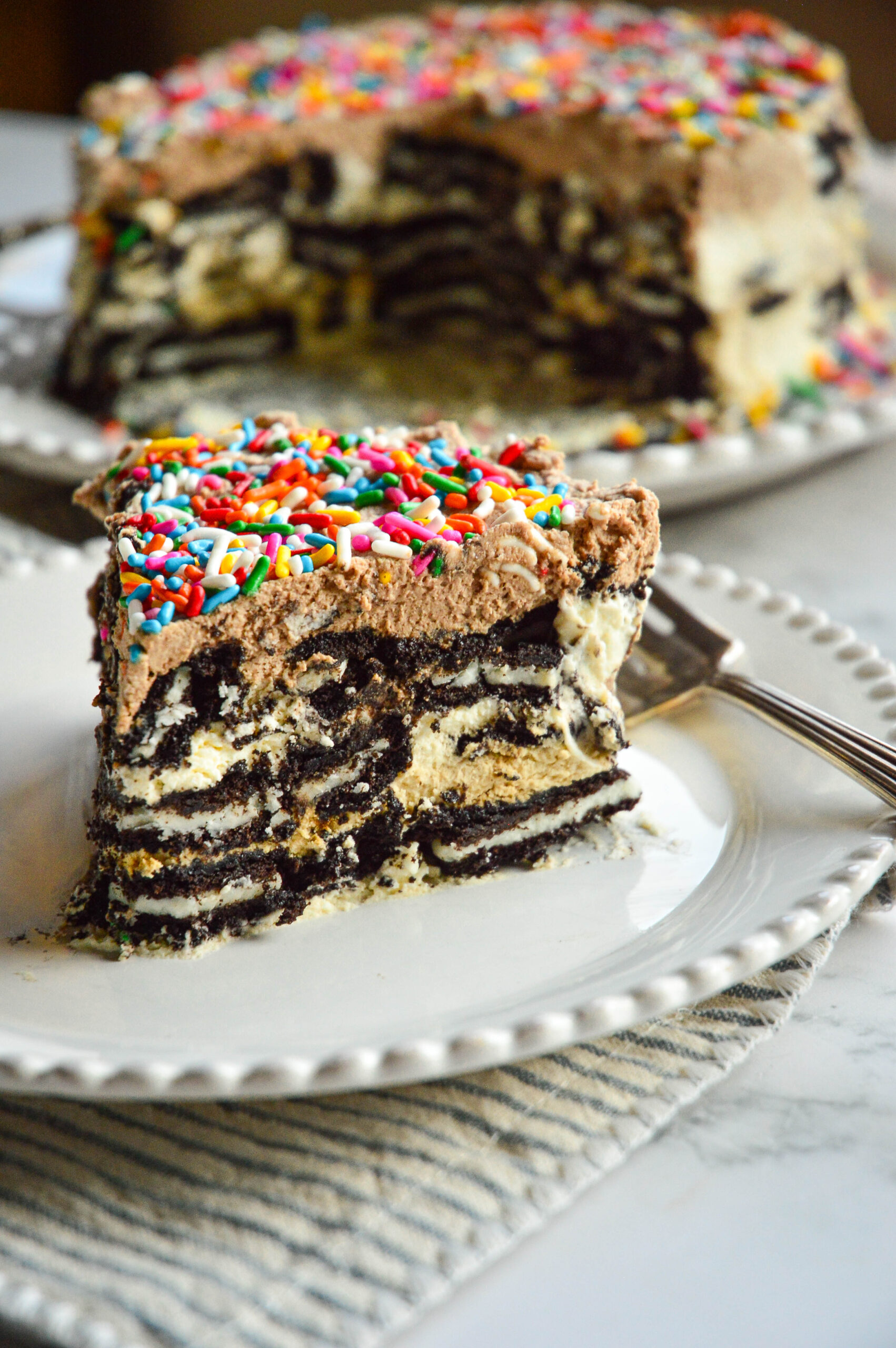 chocolate wafer icebox cake recipe on white plate and striped napkin with fork