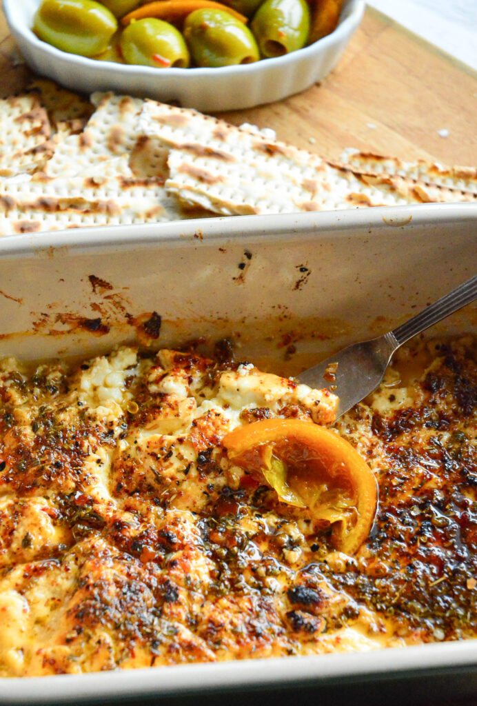 warm feta dipin casserole dish with olives
