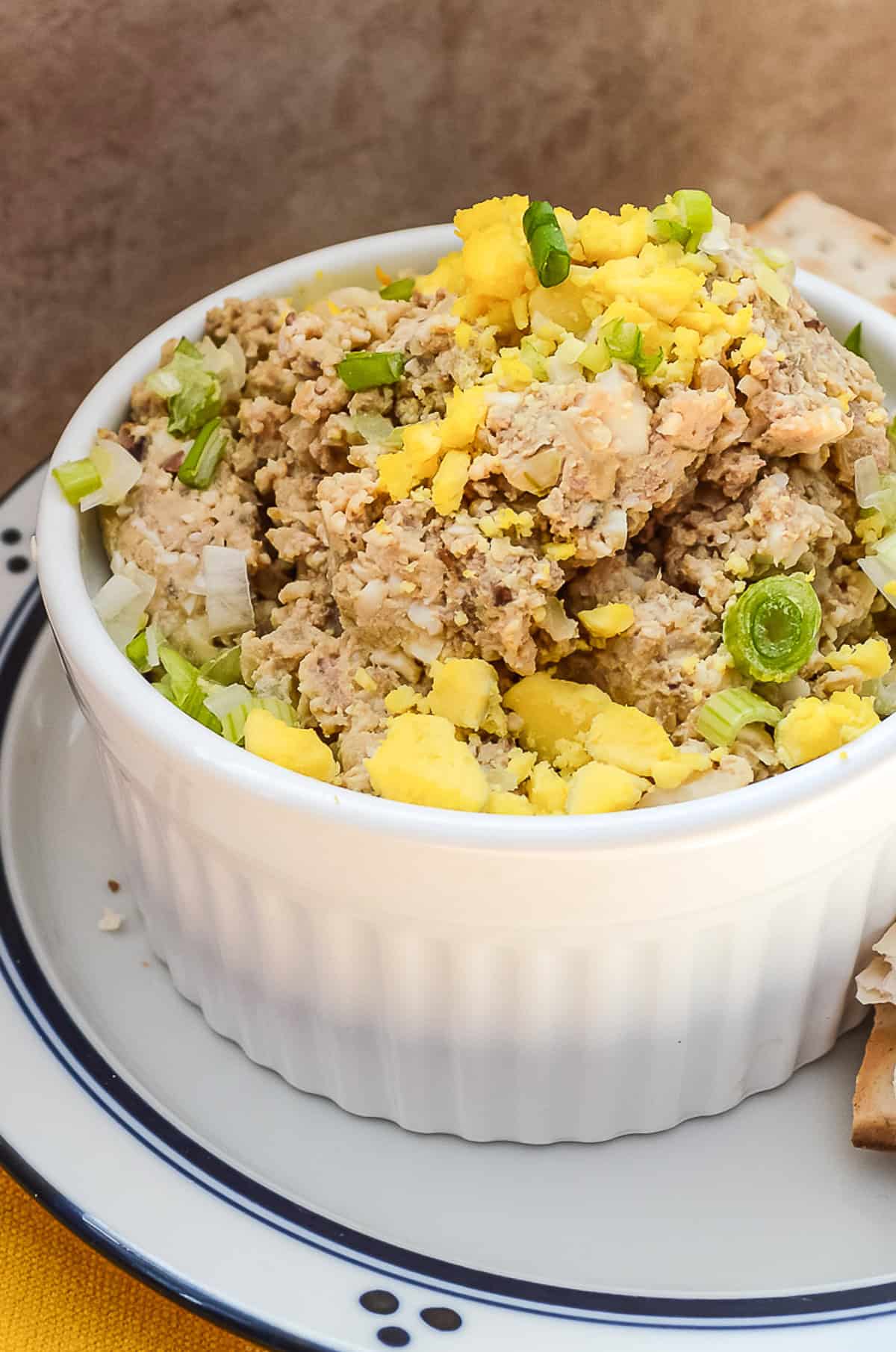 chop liver in white dish on blue striped plate