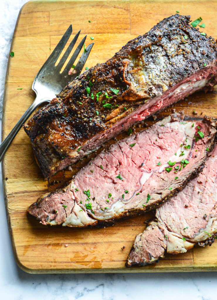 how to cook a boneless ribeye sliced on cutting board