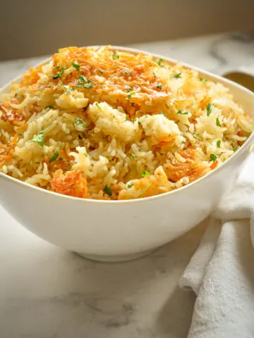 oven baked crispy golden rice in white serving bowl