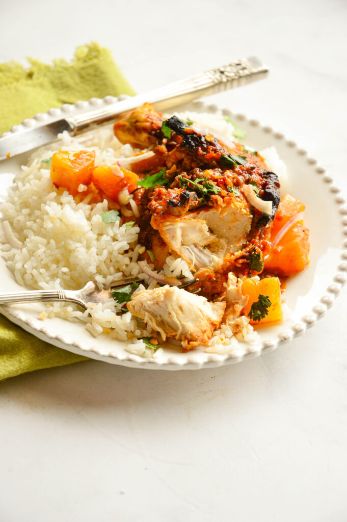 baked pineapple chicken recipe on white plate with rice