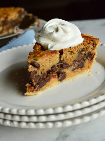 chocolate chip cookie pie on white plate with whipped cream