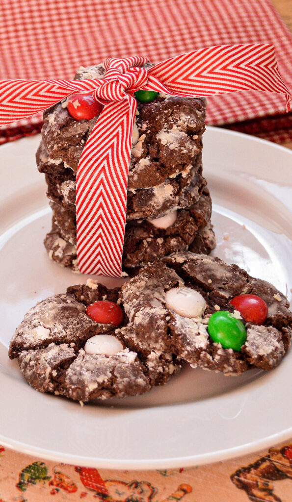 best chocolate crinkles cookie recipe on white plate with red ribbon