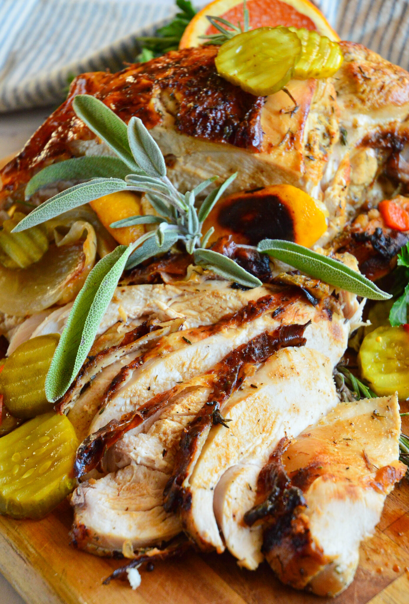 sliced turkey breast with pickles on cutting board