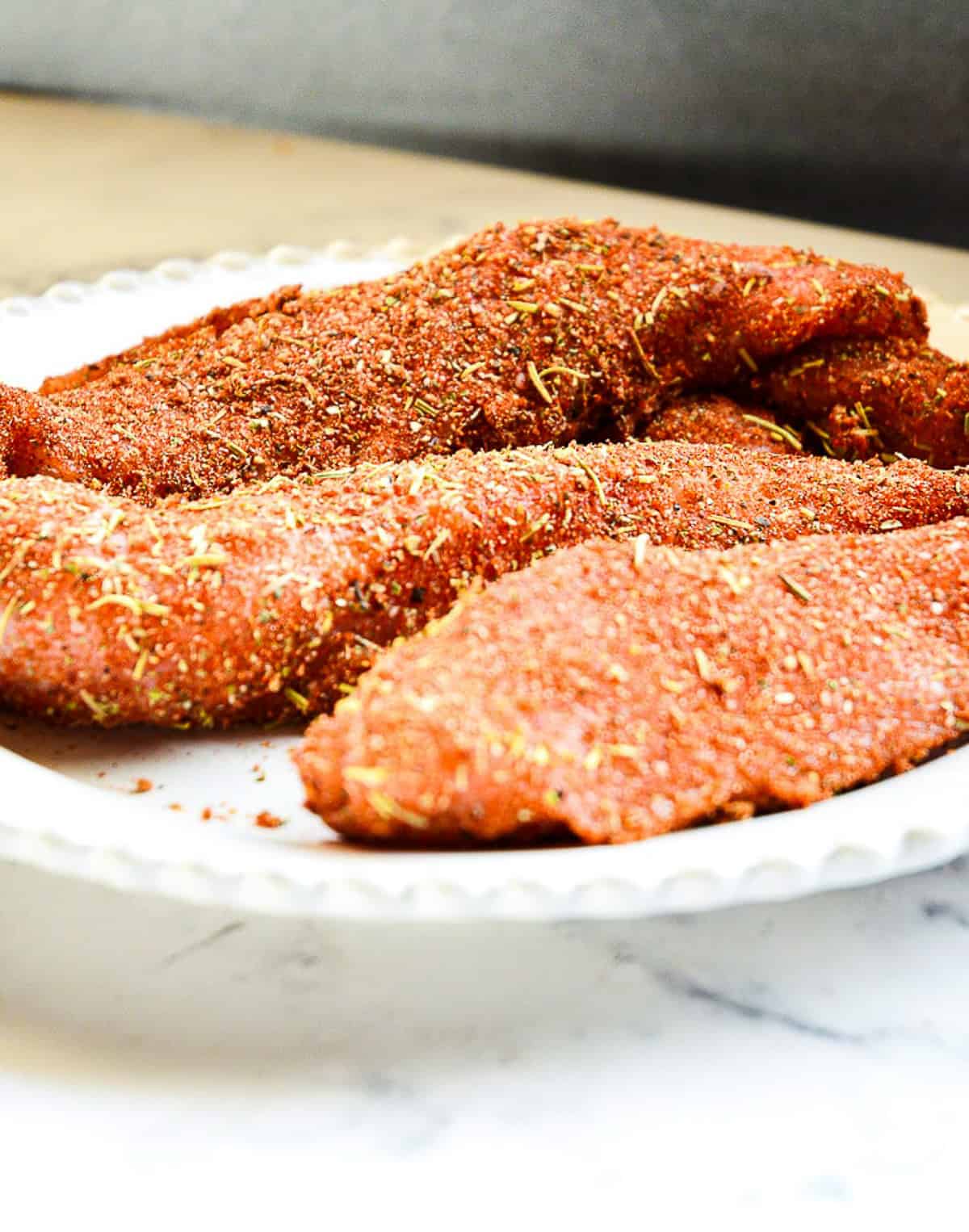 uncooked turkeey tenderloins coated with a turkey rub