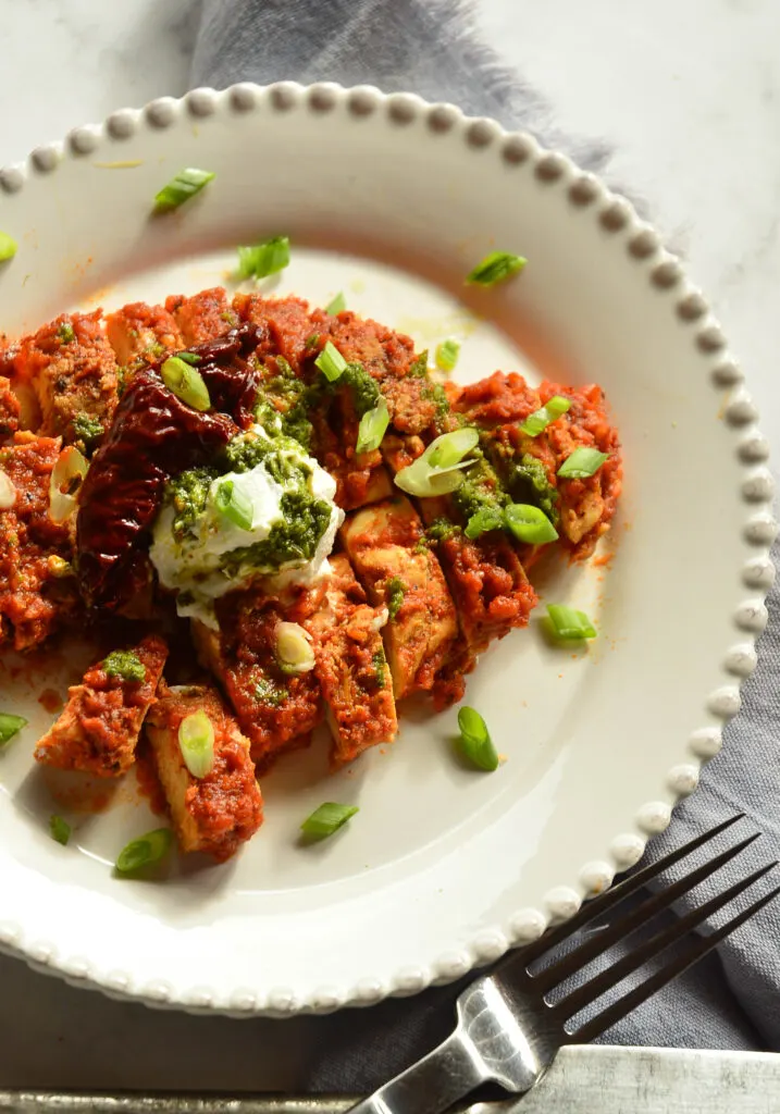 chipotle red sauce recipe over chicken on white plate