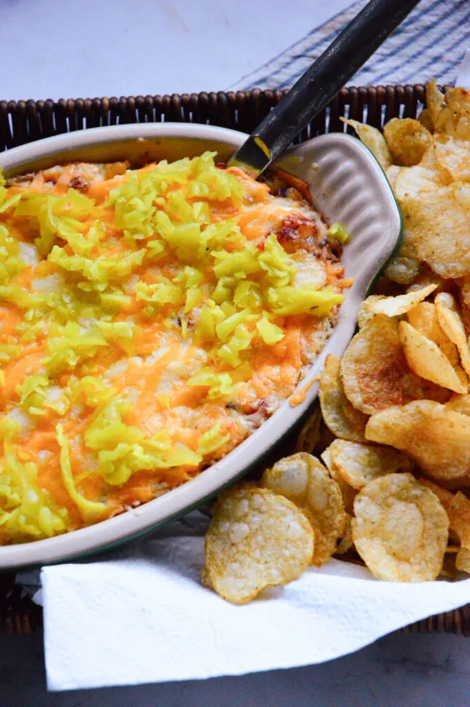 pepperoncini philadelphia cream cheese dip recipe in baking dish with potato chips