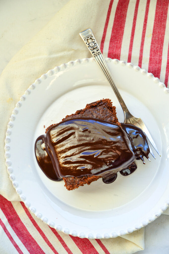 dairy free chocolate cake recipe with chocolate glaze on white plate