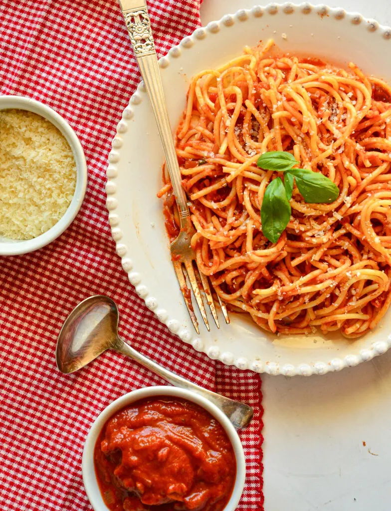 Italian Red Sauce Recipe with spaghetti on plate and sauce in bowl