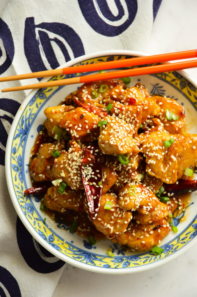 Chinese Sweet and Spicy Chicken Recipe in Asian bowl with chopsticks