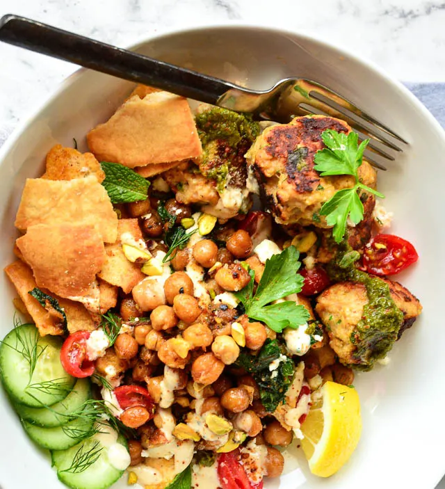 sauteed spinach and chickpeas pita salad in white salad bowl