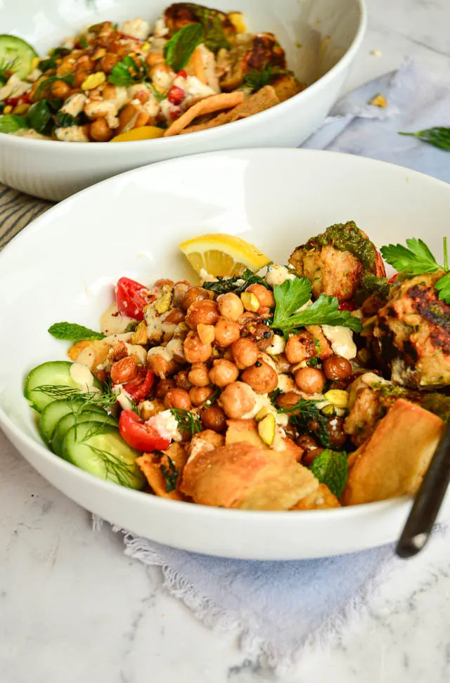 sauteed spinach and chickpeas pita salad bowl with white bowl