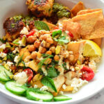 sauteed spinach and chickpeas salad pita bowl in white bowl