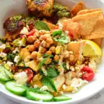 sauteed spinach and chickpeas salad pita bowl in white bowl