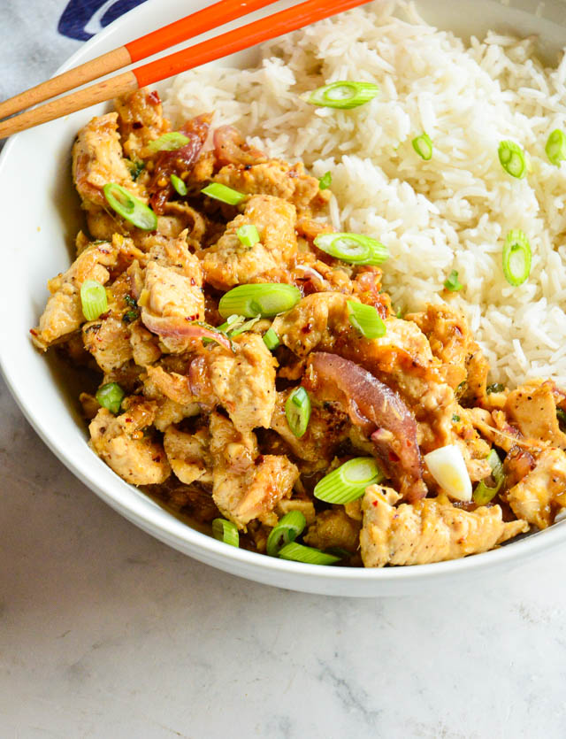 lemongrass chicken Vietnamese recipe in white bowl with orange chopsticks.