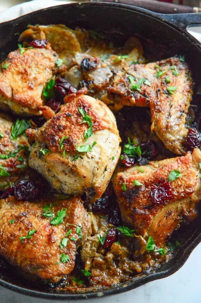 dutch oven or skillet garlic braised chicken thighs recipe with cherries