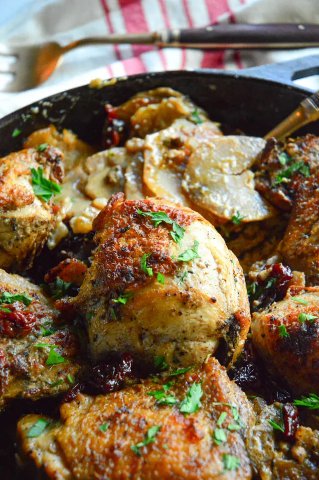 Garlic Braised Chicken thighs recipes with cherries, potatoes and mushrooms in skillet