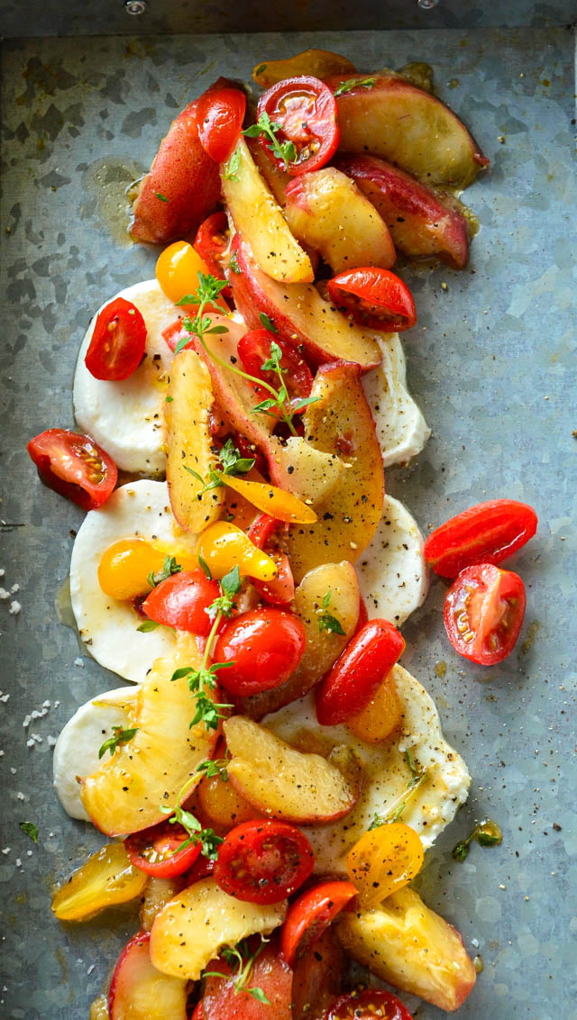peach tomato caprese salad on tin plate