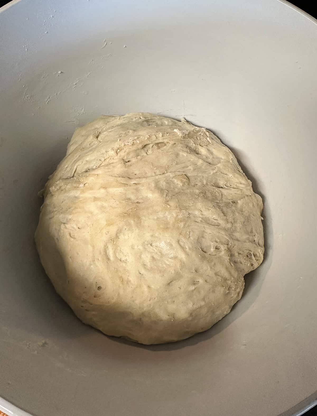 cinnamon roll focaccia dough after it has risen in bowl