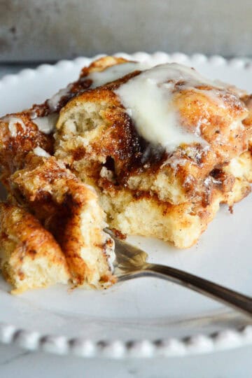 cinnamon roll focaccia with fork on white plate