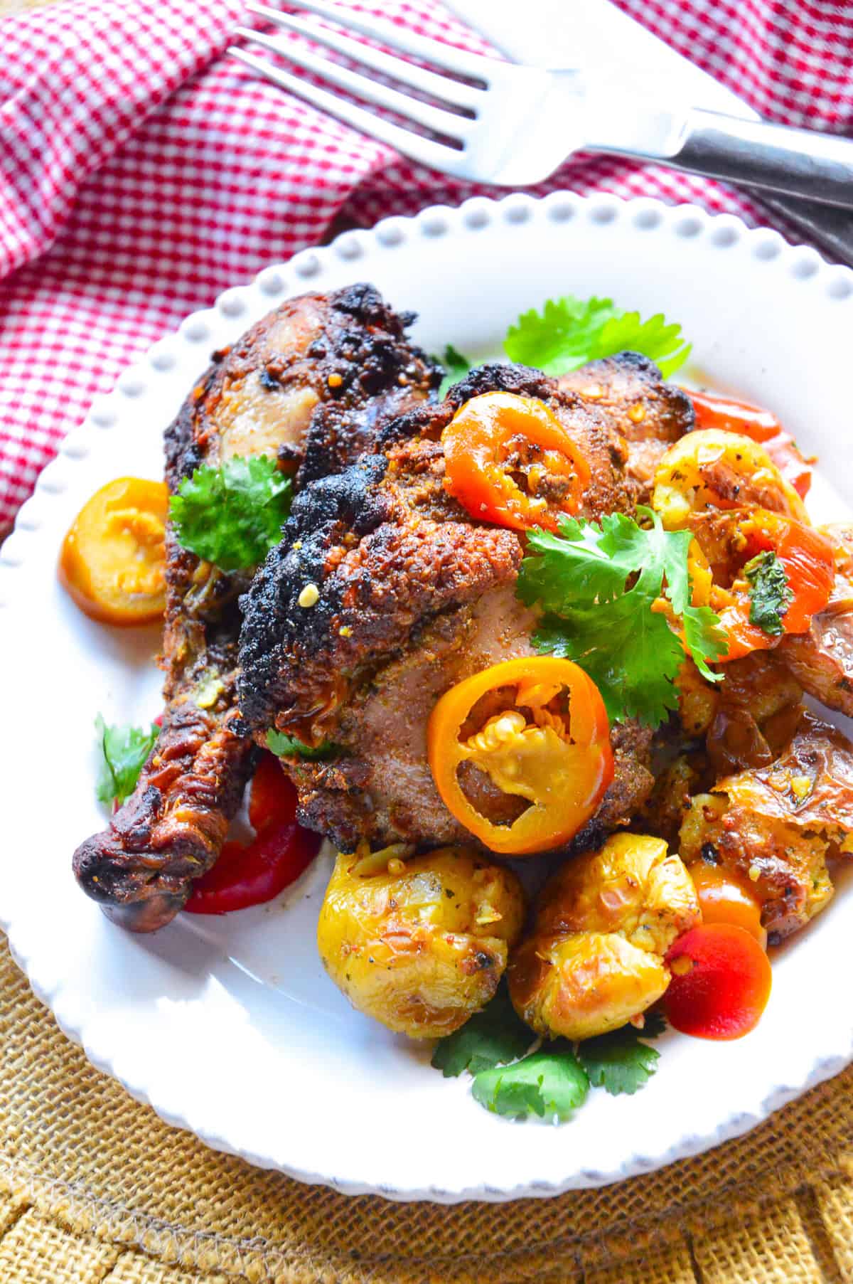 banana pepper chicken on white plate with red check napkin
