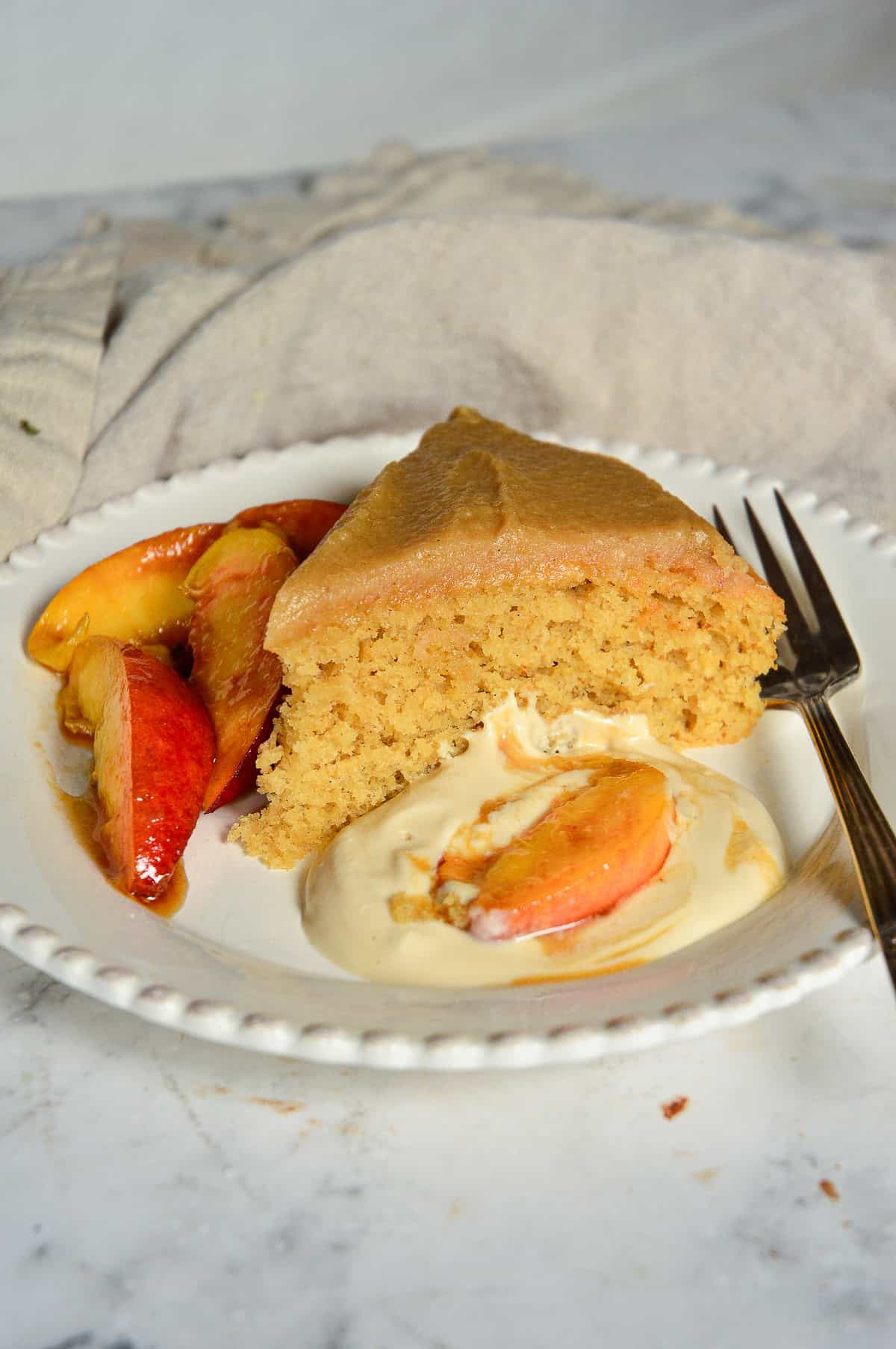 slice of buttermilk cake recipe with fresh peaches and sour cream sauce