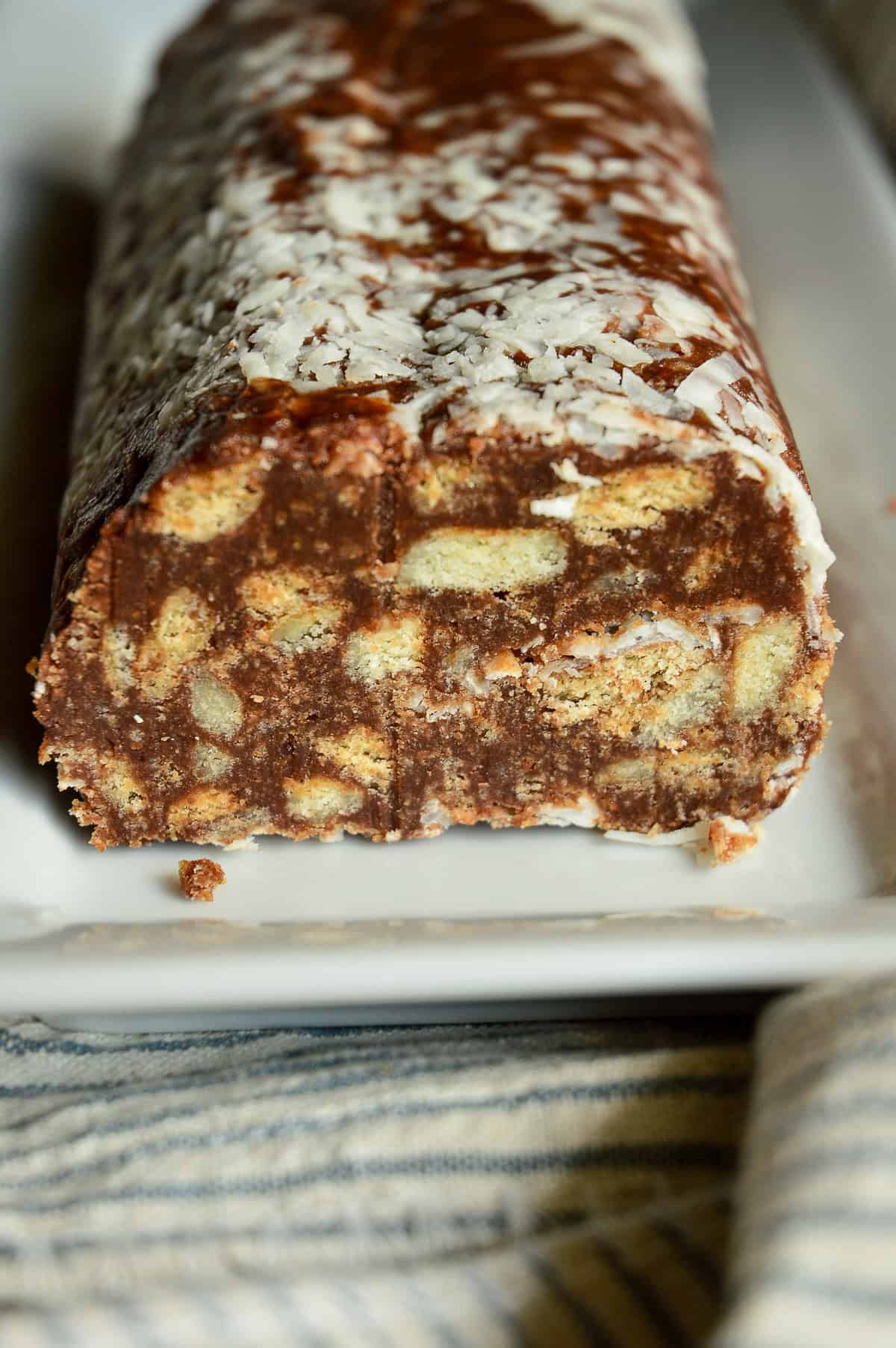 whole chocolate salami on white rectangle plate