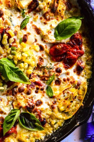 corn lasagna in a skillet with blue striped napkin
