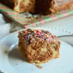 marble cake square on white plate with marble cake in background