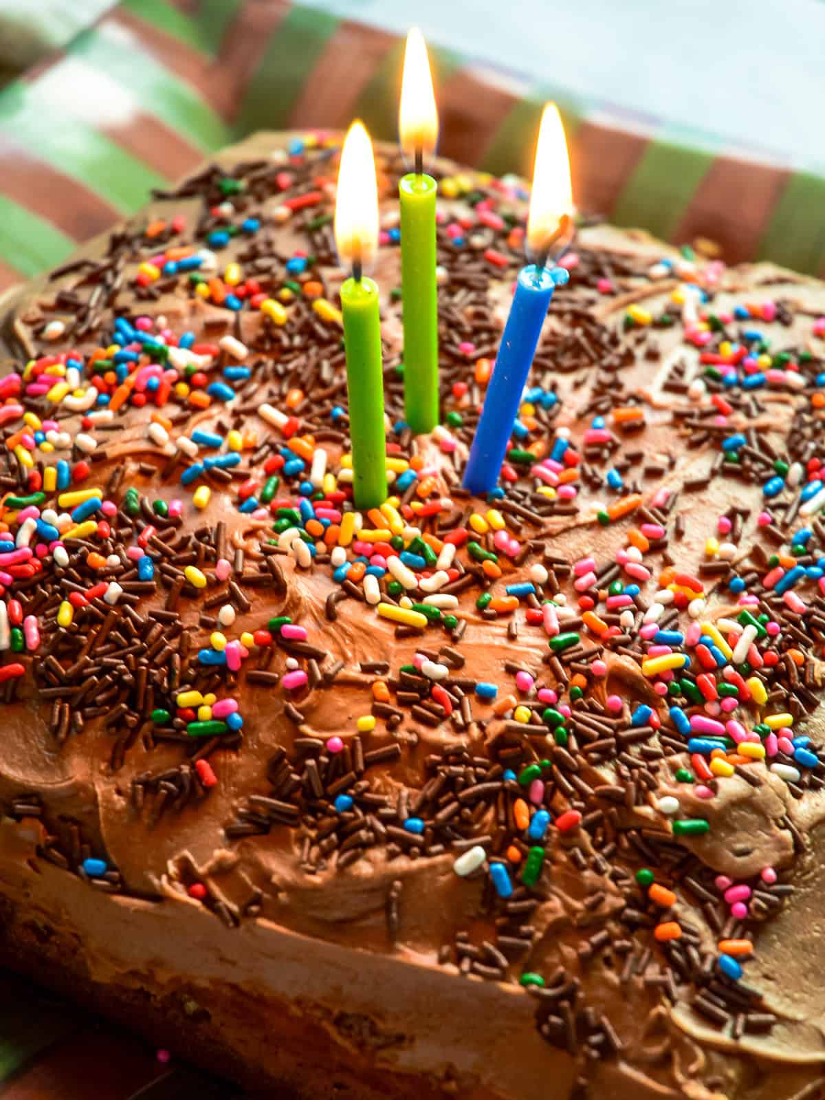 marble cake recipe with birthday candles and sprinkles on striped plate