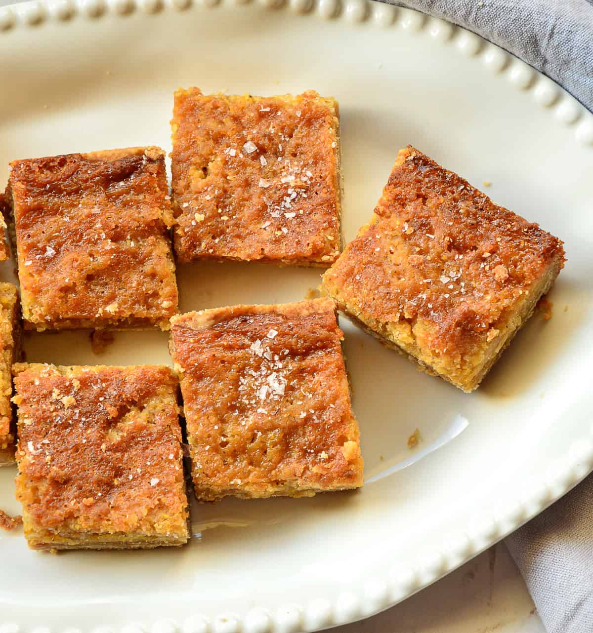 top down look of salted honey bars with brown butter on white plate