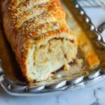 potato knish in strudel form on silver platter