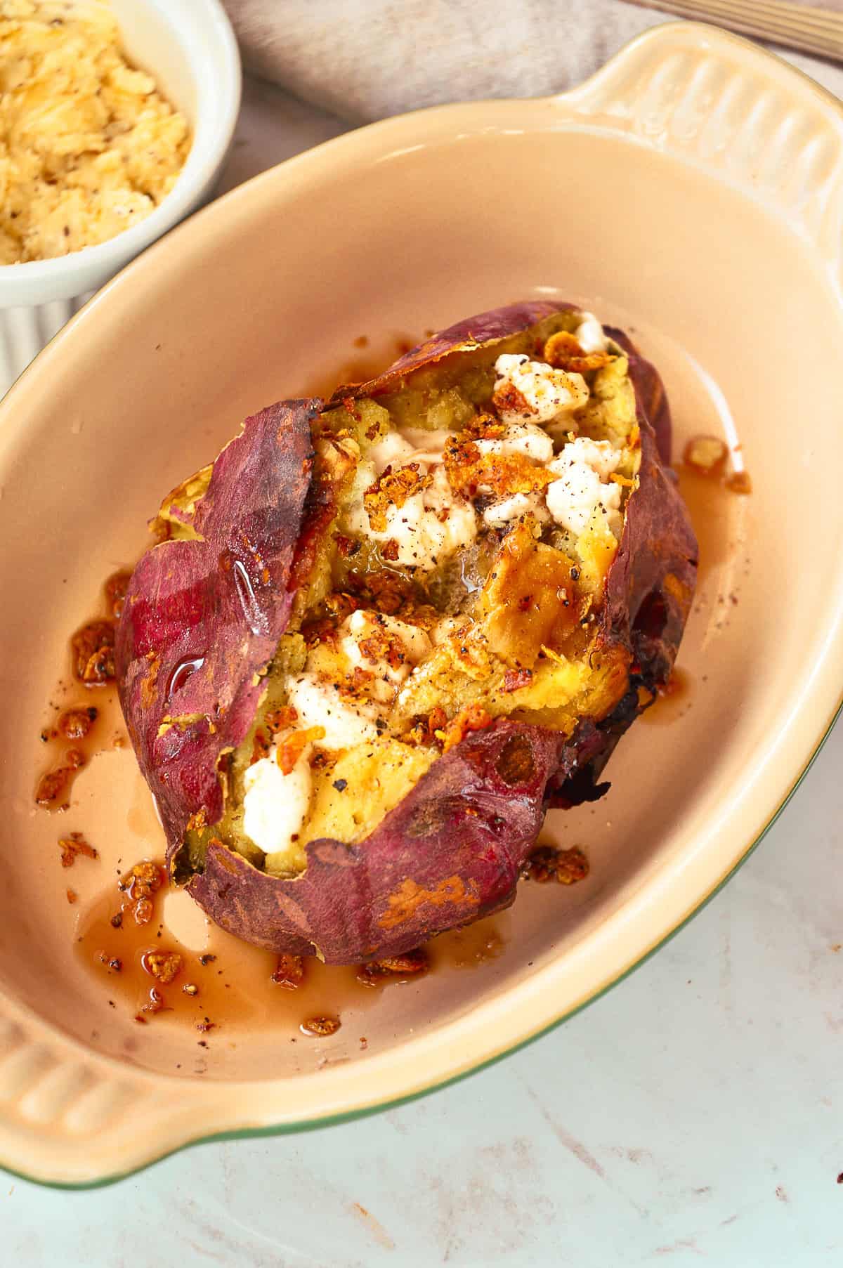 top down view of baked Japanese sweet potato with black pepper maple butter, marshmallows, rice krispies and cinnamon syrup