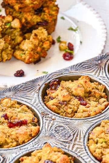 stuffing muffins in muffin tim and some on plate