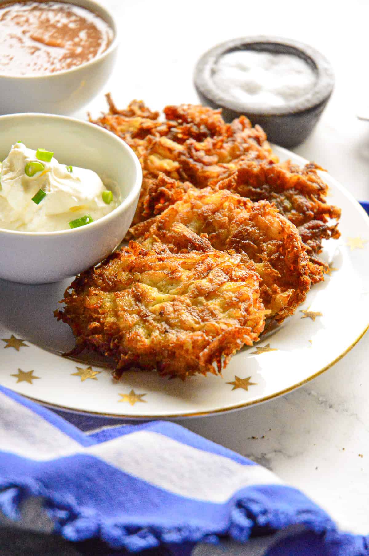 zabars latkes on star of david plate with sour creamj