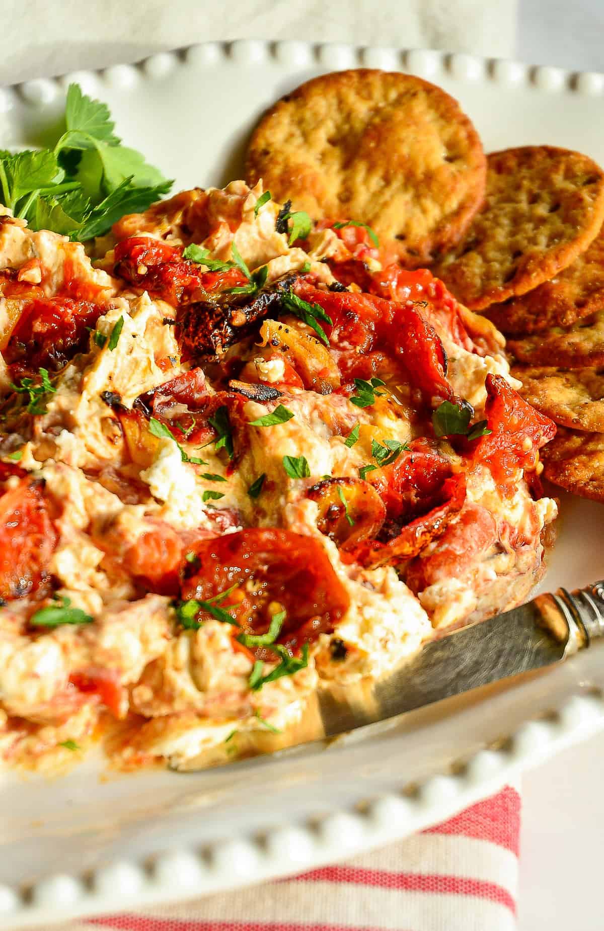 Boursin and Roasted Tomato Dip on white plate with crackers