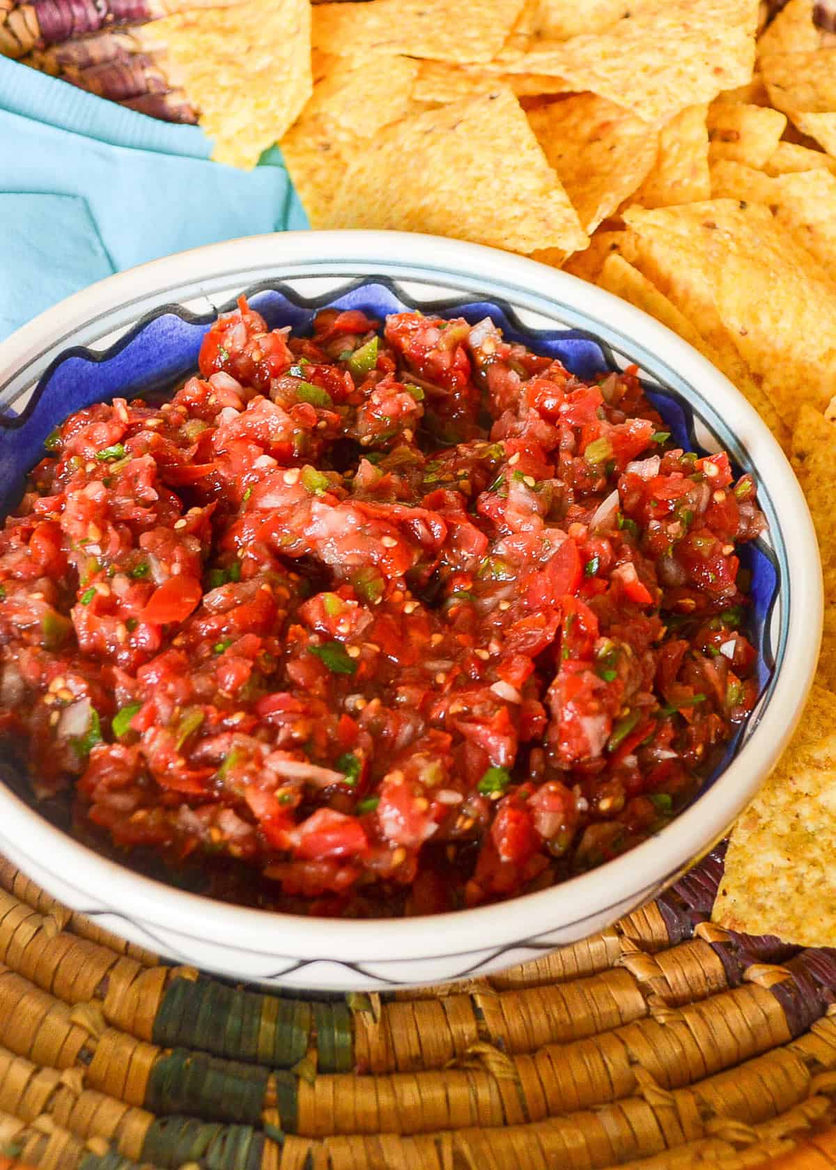 Salsa fresca or pico de gallo in a blue rimmed bowl